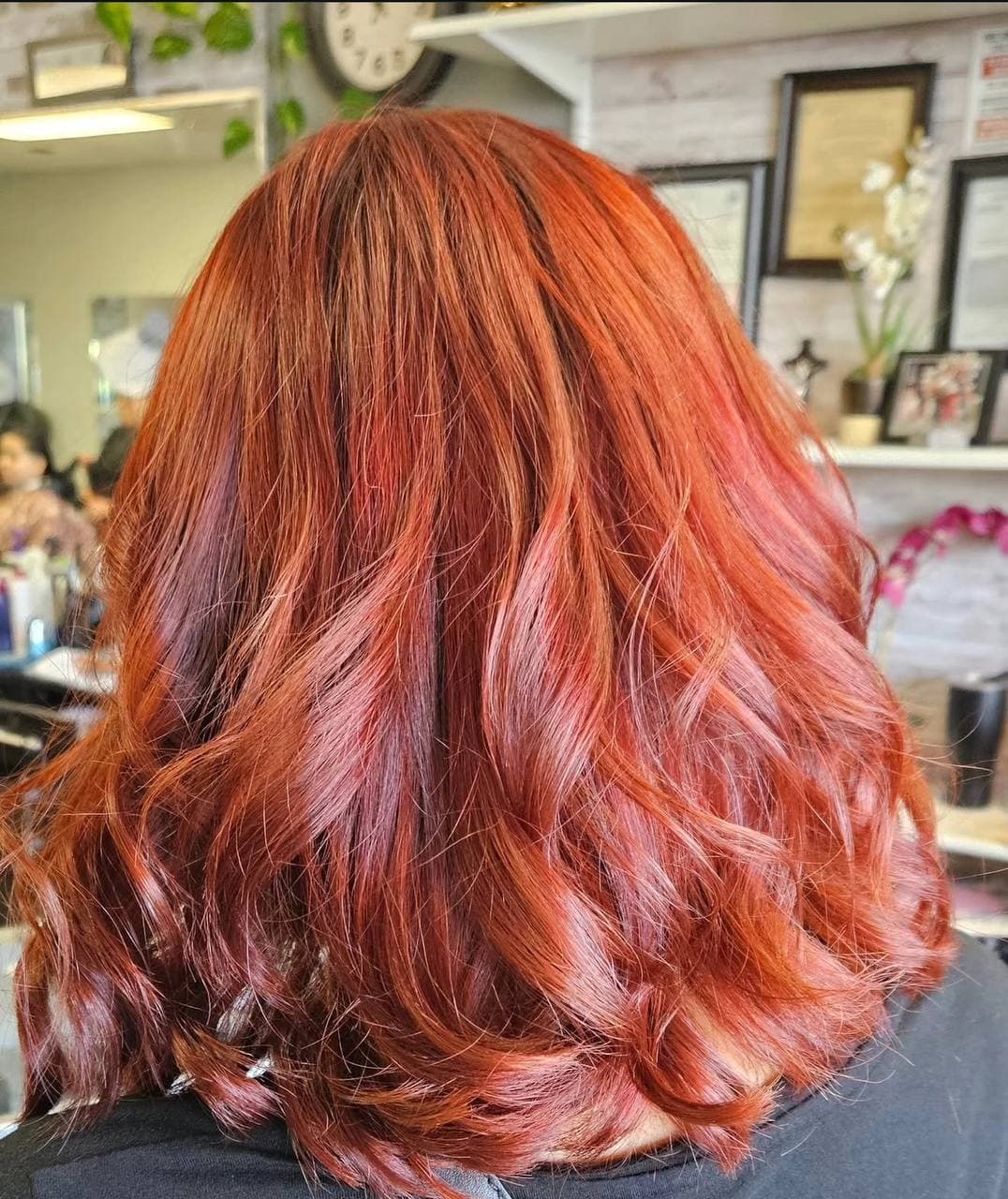 Copper red layered hairstyle with soft waves