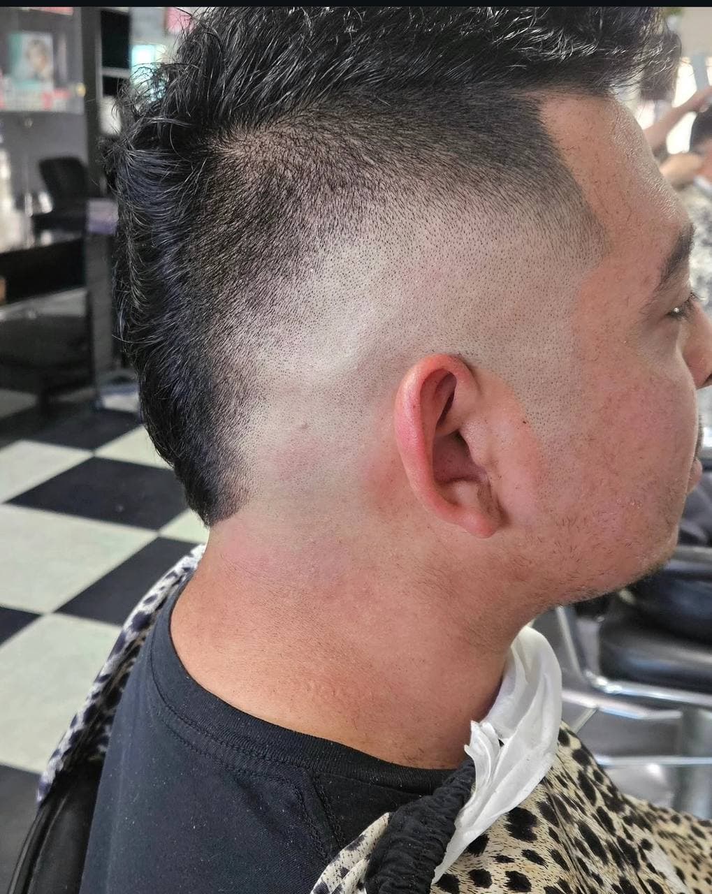 Textured men's haircut with a high fade